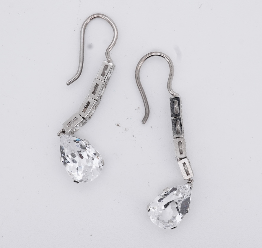 A pair of white metal and four stone diamond set earrings, each with a cubic zirconia pear shaped drop, overall 42mm.